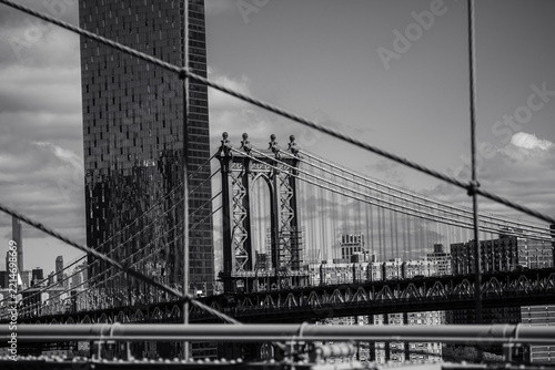 Manhattan Bridge behind foreground cables in black and white