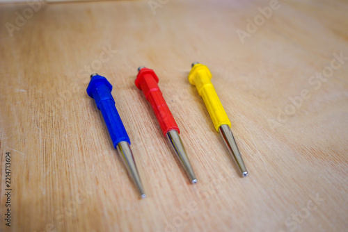 Three tool punches on a wood background