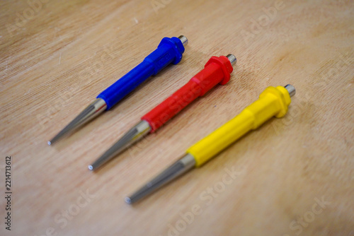 Three tool punches on a wood background