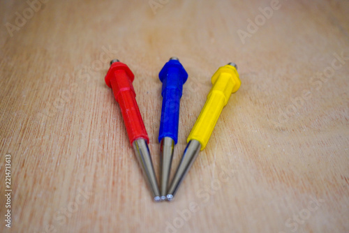Three tool punches on a wood background