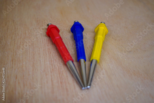 Three tool punches on a wood background