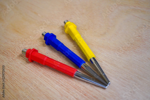 Three tool punches on a wood background