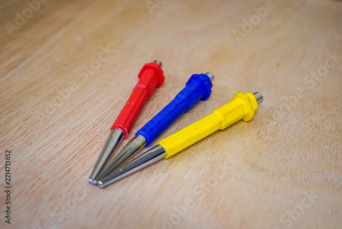Three tool punches on a wood background
