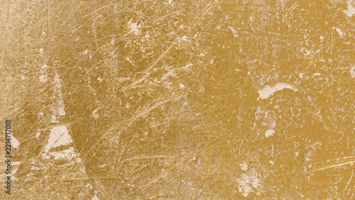 Close-up view of a golden abstract background textured Venetian plaster surfa...