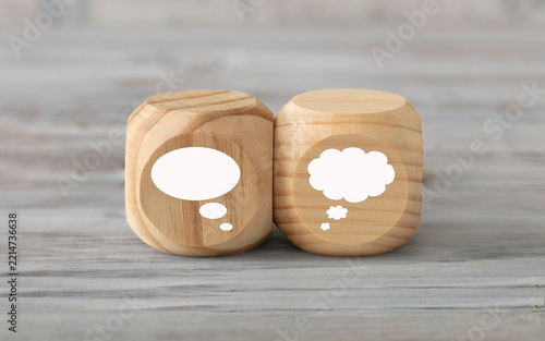 Different kinds of ideas concept. Two abstract geometric wooden dice isolate on white rustic surface. Antagonism concept.