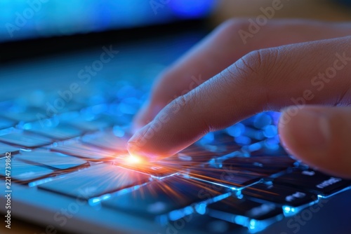 Finger taps glowing keyboard key with radiant light burst