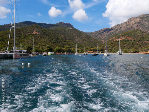 Girolata harbor view with anchored sailboats and mountain backdrop Corsica