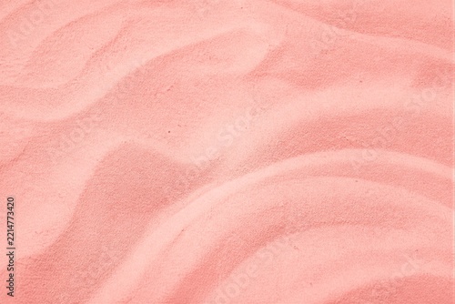 Pink sand ripples forming texture on flat surface background