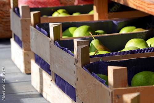 Fresh green apples in wooden crates