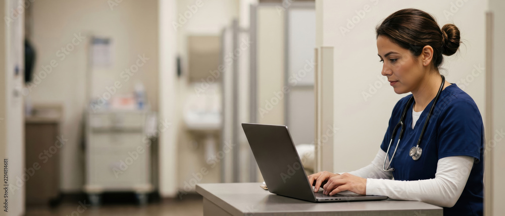 Fototapeta premium Female doctor with a stethoscope working on a laptop in a hospital ward. Medical professional nurse typing electronic health records in a clinic. Healthcare technology concept