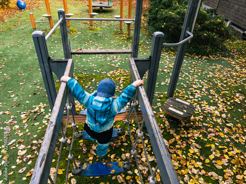 Obraz na plátně Toddler Building Confidence on Playground Climbing Course