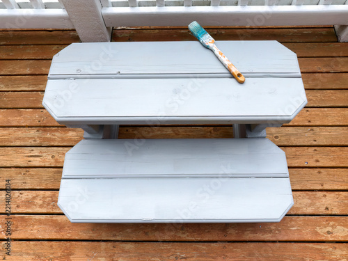 Top view of wood bench step freshly painted for outdoor use on a home deck patio