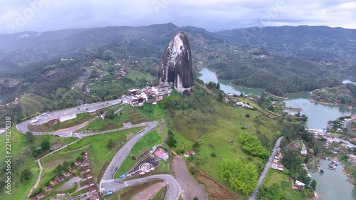Guatapé and Iconic Piedra del Peñol Surrounded by Reservoir Islands and Mountains in Colombia. Establishing Shot. Aerial View.