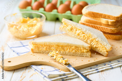 freshly made egg salad sandwiches on a white table, selective focus.