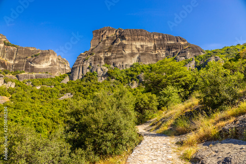 Meteora spectacular landscape in central Greece, featuring immense sandstone rock pillars rising dramatically above the surrounding valleys and countryside, with historic Orthodox monasteries position