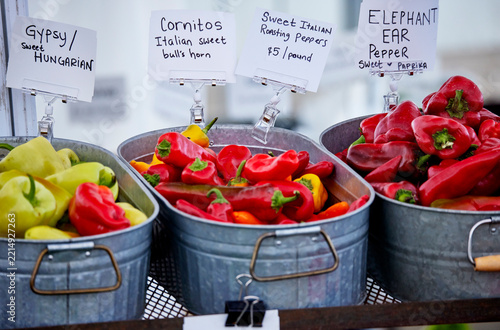 Baskets of fresh peppers for sale at an outdoor farmer's market