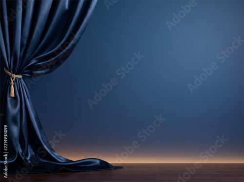 Navy satin curtain with gold tassel tieback on a blue stage wall