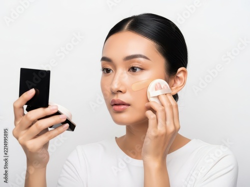 Woman applying makeup with beauty sponge