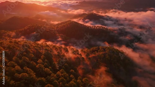 Aerial view of mountain valley with clouds at golden hour