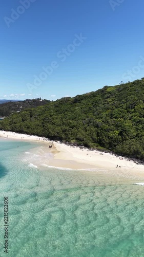 Aerial view of families swimming in the clear water of Tallebudgera Creek, Gold Coast, Queensland Australia - vertical video