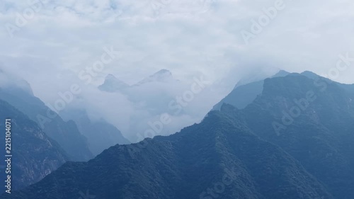 misty mountain peaks shrouded in soft clouds