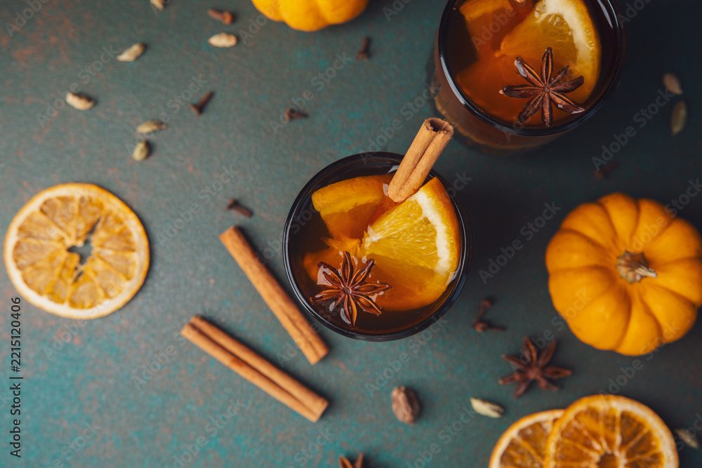 Fototapeta premium White mulled wine with orange and spices surrounded by pumpkins for autumn gatherings