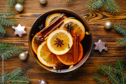 Hot spiced punch with oranges cinnamon and star anise on a wooden background