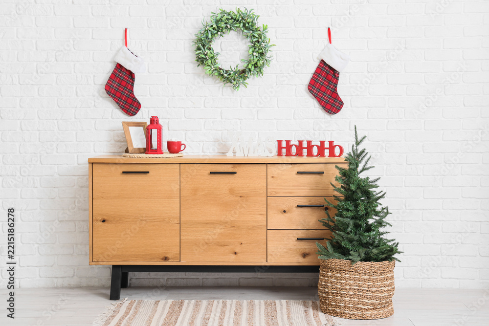 Fototapeta premium Interior of room with commode, Christmas tree and wreath