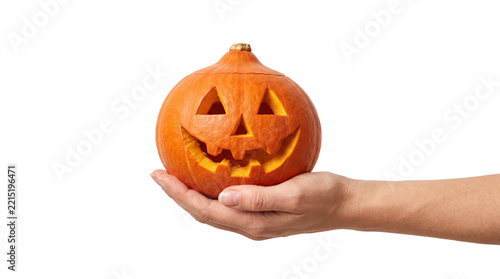 Hand holding a carved orange halloween pumpkin jack-o-lantern