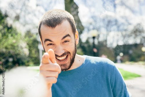 Laughing man pointing on viewer