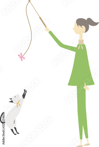 女性とねこじゃらしで遊んでいる猫