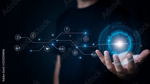 Human hand presenting a glowing digital sphere connecting global network and advanced technology solutions