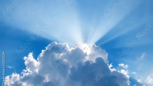 Heavenly Rays: Brilliant sunbeams pierce through a dramatic cloud formation, casting ethereal rays of light across a clear blue sky, evoking a sense of wonder and divine presence.