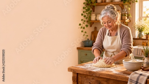 Senior woman kneading dough in a warm rustic kitchen with open space