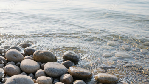 Smooth river stones in clear shallow water