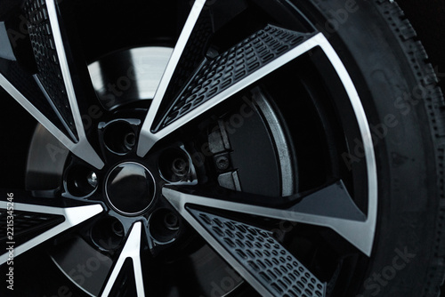 Obraz na plátně Close-up of modern black and silver alloy wheel rim with brake caliper