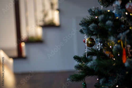 Decorated Christmas tree glowing warmly in cozy home interior
