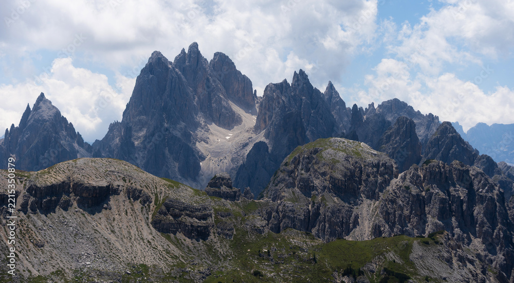 Naklejka premium Mountain landscape panorama Tre Cime Mount against a blue summer background. 