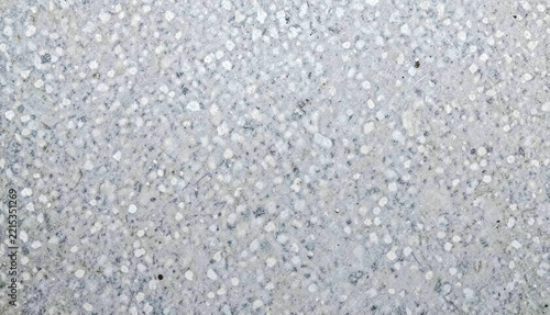 White speckled concrete surfaces reflect light, creating a textured, grainy pattern. It’s a close-up shot.
