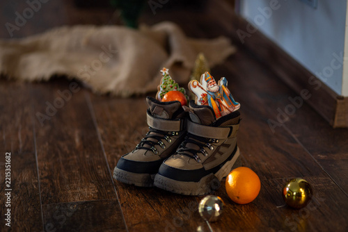 Christmas Candy and Wrapped Presents in Outdoor Boots