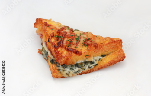 Delicious croque monsieur sandwich stuffed with savory ham, spinach, and melted cheese, isolated on a white background.