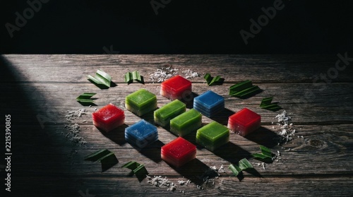 Traditional colorful layered rice cakes on a rustic wooden table with copy space