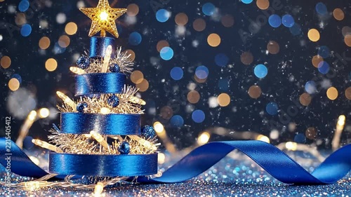 Blue ribbon forming a christmas tree with lights and sparkling snowflakes