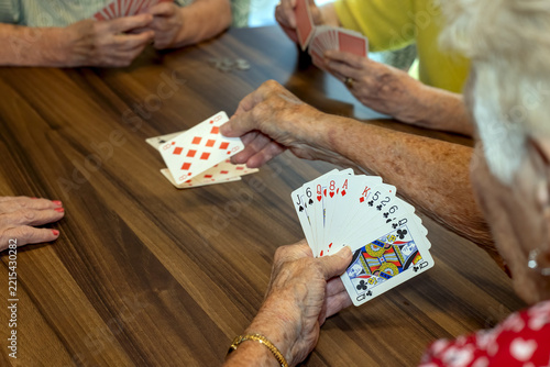 A group of older ladies enjoing a card game