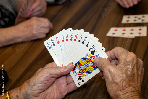 A group of older ladies enjoing a card game