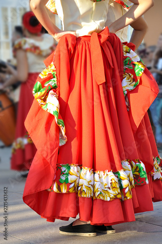 Dancers performing and wearing traditional folk costumes from Chile