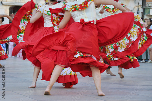 Dancers performing and wearing traditional folk costumes from Chile