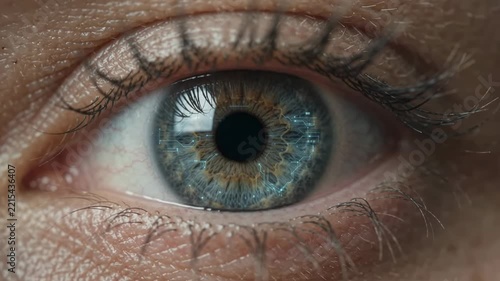 Close-up of a human eye with cybernetic implants and digital data overlay