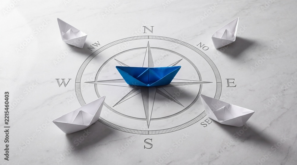 Fototapeta premium Blue paper boat standing out on a compass rose symbol surrounded by white paper boats, representing leadership, strategic business direction, vision, guidance, and finding the right path.