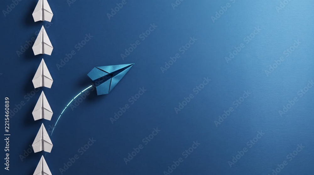 Fototapeta premium Leadership and Innovation Concept with a Blue Paper Airplane Breaking Away from a Row of White Planes on a Blue Background, Symbolizing Business Growth, Uniqueness, Creative Strategy, and Success.